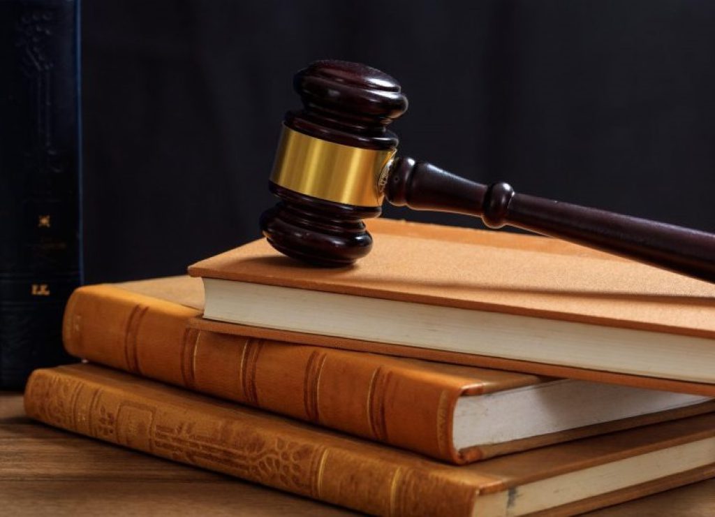judge-gavel-on-law-books-wooden-desk-2021-08-26-16-34-03-utc-scaled-e1654276773740